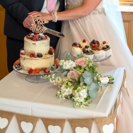 Buttercream Wedding Cake with Summer Berry Cupcakes.
